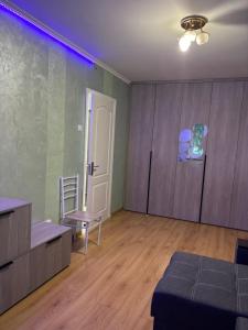 a living room with a couch and a chair at MILANIA однокомнатная квартира in Poltava