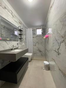 a bathroom with a sink and a toilet at Rajan Rooms in Vlorë +46 photos