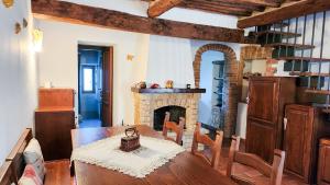 a dining room with a table and a fireplace at Casina nel Chianti in Vagliagli