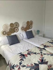 a bedroom with a bed with a quilt on it at La casa del mar in Zahara de los Atunes