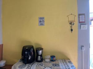 a table with a coffee maker on top of it at Viver a paz, praia & home office rua Nelson Pecegueiro do Amaral, 267, costa azul in Rio das Ostras