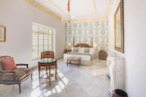 a bedroom with a bed and a table and chairs at Soho Boutique Duques de Medinaceli - Adults Recommended in El Puerto de Santa María