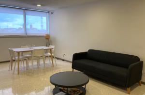 a living room with a couch and a table at Habitación Shefa Solar 3 in Puebla