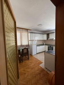 a kitchen with white cabinets and a table and a tableablish at S&S Comfort Flat in Konjic