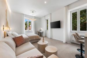 a white living room with a couch and a table at Adam and Cupid in Dubrovnik