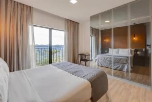 Ένα ή περισσότερα κρεβάτια σε δωμάτιο στο Gran Paradiso Resort Campos do Jordão
