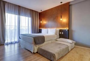 Ένα ή περισσότερα κρεβάτια σε δωμάτιο στο Gran Paradiso Resort Campos do Jordão +2 φωτογραφίες