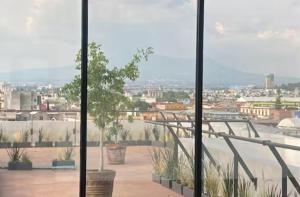 a view of a city from a glass window at Habitación Shefa Solar 3 in Puebla