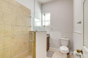 a bathroom with a shower with a toilet and a sink at Less Than 1 Mi to Seawall Convenient Galveston Getaway! in Galveston +16 photos