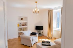 a living room with a chair and a tv at Ghiffa villa rental in Ghiffa