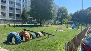 a park with a bunch of tires on the grass at Apartman Chill day in Michalovce