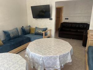 a living room with a couch and a table at Casa Marina Saïdia in Saïdia