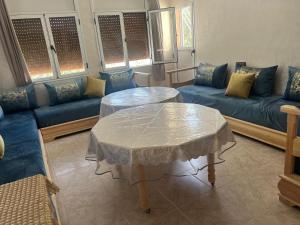 a living room with a table and a couch at Casa Marina Saïdia in Saïdia