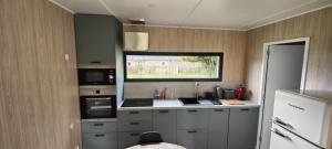 a small kitchen with a counter and a window at La Cabane du Gouët in Saint-Julien