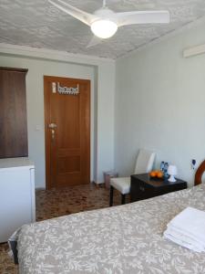 a bedroom with a bed and a door and a chair at Cozy room in Denia