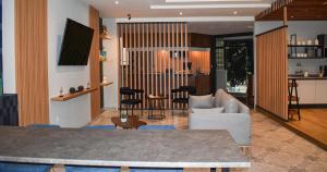 a living room with a couch and a table at Uniko Living Roma in Mexico City