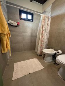 a bathroom with a sink and a toilet and a window at LA BRUJA BUENA Casa Boutique in Loreto +38 photos