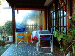 a table and chairs sitting on a patio at Casa en Playas de Oro in Villa Carlos Paz +4 photos