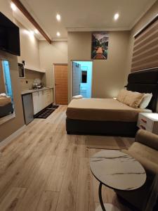 a bedroom with a bed and a living room at ARCHITECT's VIEW SUITE 1 in Durban