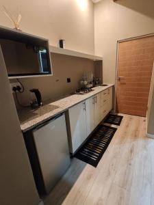 a kitchen with white cabinets and a counter top at ARCHITECT's VIEW SUITE 1 in Durban +9 photos