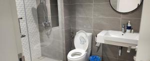 a bathroom with a toilet and a sink at Luxury Suites at Wyndham KLCC in Kuala Lumpur +23 photos