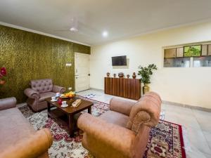 a living room with two couches and a table at The Khayabaan - Your Fully Equipped Air-Conditioned Serviced Apartments in Srinagar in Srinagar