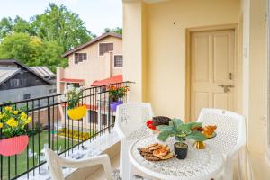 a table with a plate of food on a balcony at The Khayabaan - Your Fully Equipped Air-Conditioned Serviced Apartments in city centre in Srinagar