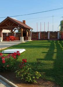 a yard with two surfboards on the grass at Pensiunea La Tavi in Murighiol