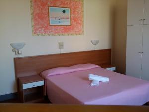 Postel nebo postele na pokoji v ubytování Hotel Eros