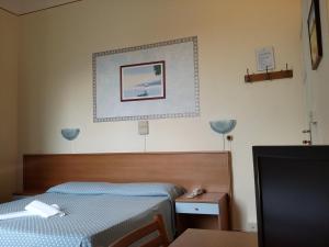 Postel nebo postele na pokoji v ubytování Hotel Eros