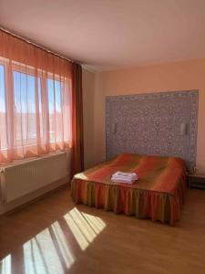 a bedroom with a bed and a large window at Къща за гости ГАЛАНТ in Byala +40 photos
