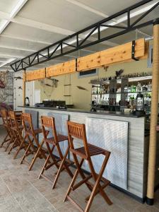 a row of chairs sitting at a bar at Къща за гости ГАЛАНТ in Byala