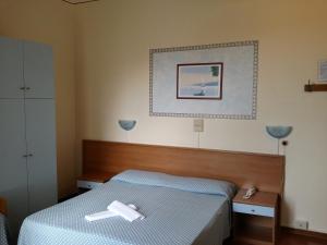 Postel nebo postele na pokoji v ubytování Hotel Eros