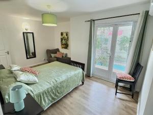 a bedroom with a bed and a sliding glass door at RacinesTropicalesFlic-en-Flac in Flic-en-Flac +17 photos
