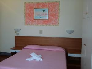 Postel nebo postele na pokoji v ubytování Hotel Eros