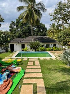 a backyard with a swimming pool and a house at BiG LUXURY VILLA in Dar es Salaam