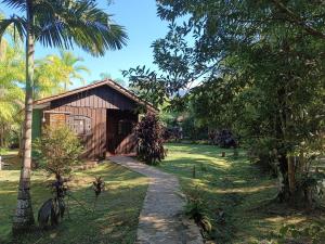 a small house in the middle of a yard with trees at Brisa da Mata Ecolodges in Morretes