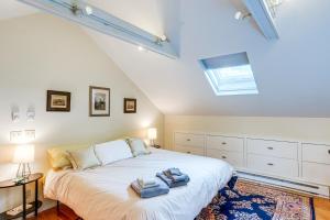 a bedroom with a large bed with towels on it at Steps to Downtown Stockbridge Home with Patio! in Stockbridge