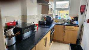 a small kitchen with a stove and a sink at UnknownRooms-75 in Plumstead