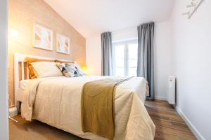a bedroom with a bed and a window at Charming Santo Antonio Roof top in Monção