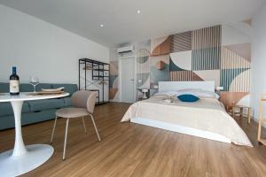 a bedroom with a bed and a table and a chair at SolVerdi in Oristano