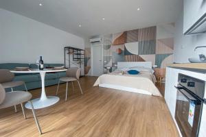 a bedroom with a bed and a desk and a table at SolVerdi in Oristano +24 photos