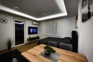 a living room with a table and a couch at CHlLL HILL in Vrnjačka Banja