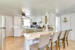 a white kitchen with a table and chairs at 2 Mi to Public Beach Pet-Friendly Freeport Home! in Freeport +16 photos
