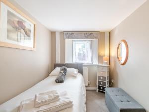 a small bedroom with a bed and a window at 2 Bed in Cosheston FB060 in Cosheston