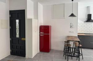 a kitchen with a red refrigerator and a table at Apartamento Rosina Ávila Center in Avila