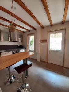 a kitchen with a wooden counter in a room at Charmante maisonnette in Pontarlier