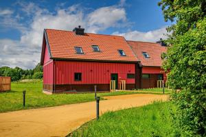a red barn with a red roof on a dirt road at Ash View 2 in Corsley