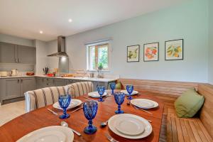 a dining room table with plates and glasses on it at Ash View 2 in Corsley +10 photos