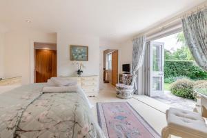 a bedroom with a bed and a large window at Riverside Cottage - Wareham in Wareham